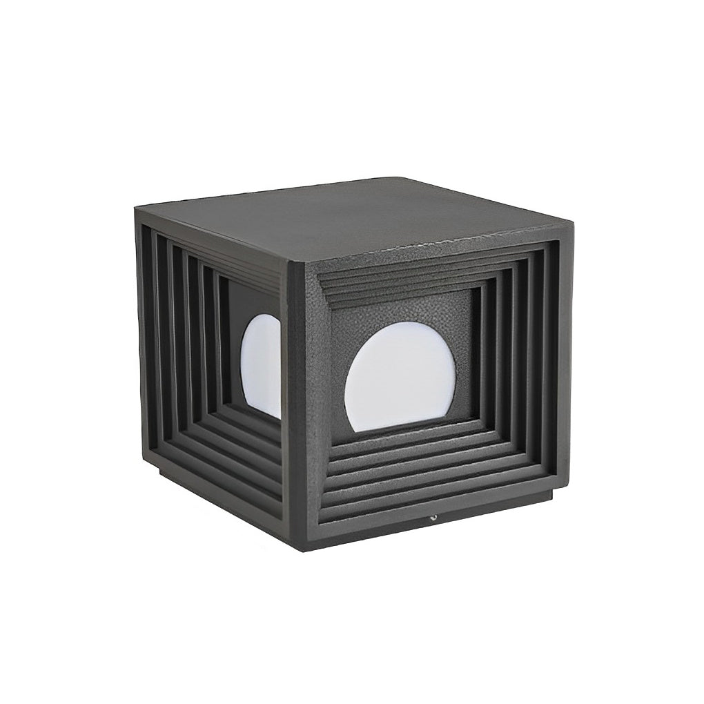Modern outdoor pillar lights with a black finish, providing elegant light near a garden.