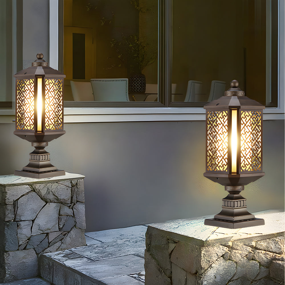 Modern outdoor pillar lights with a black finish, providing soft lighting near a pathway.