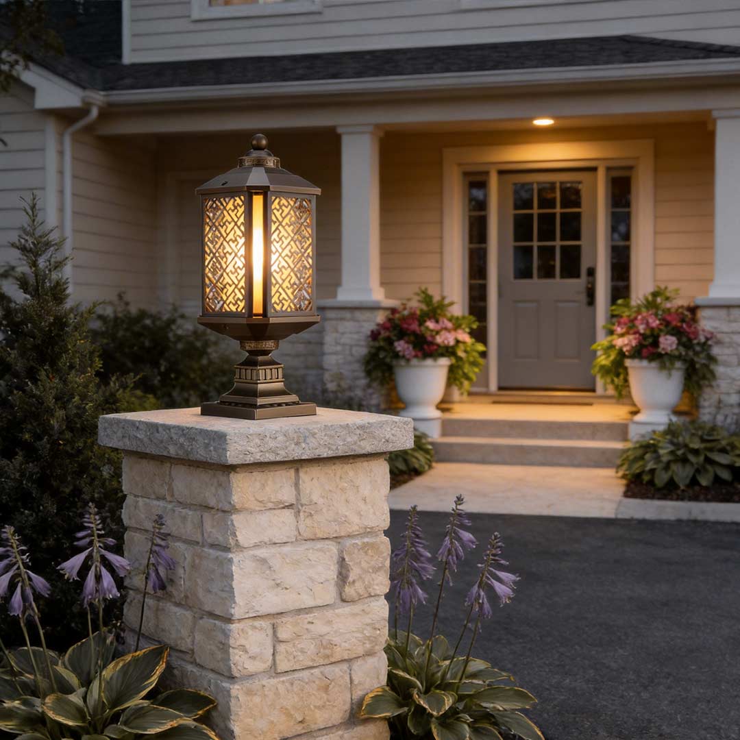 Modern outdoor pillar lights illuminating the entrance pathway of a classic house.
