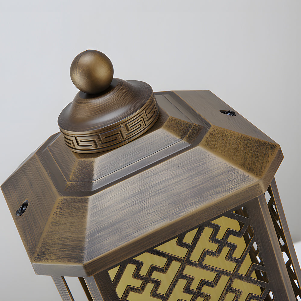 Close-up of modern outdoor pillar lights showcasing detailed bronze and glass design.
