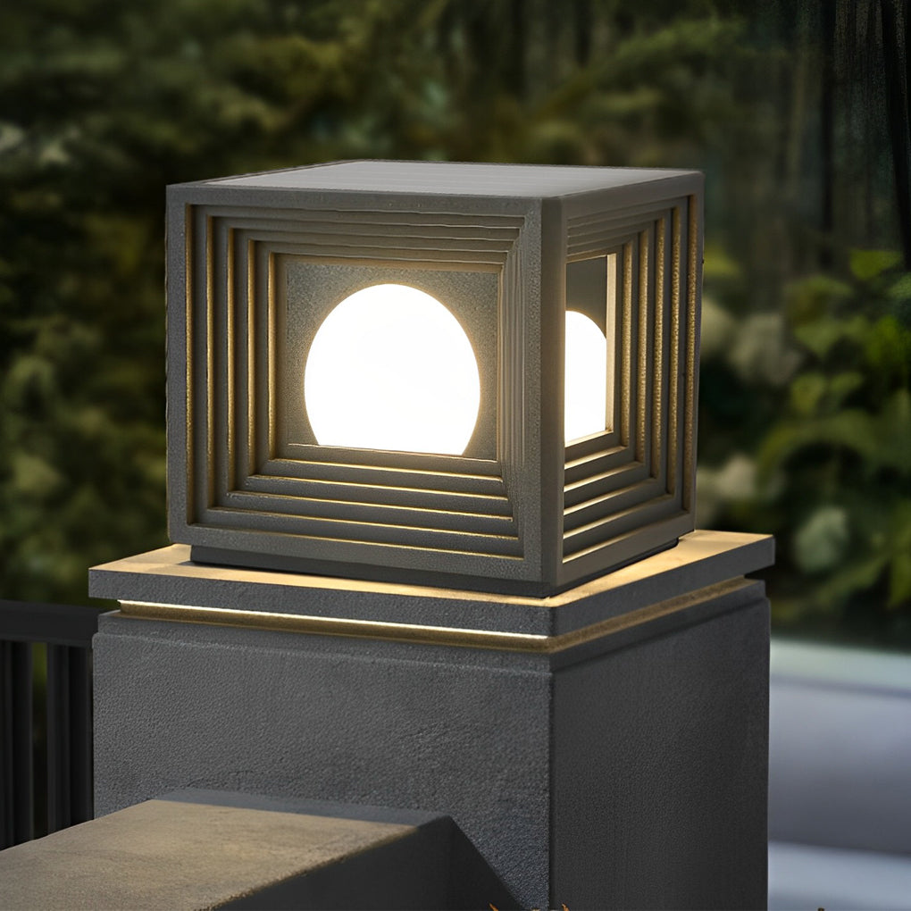 Modern outdoor pillar lights with a close-up of their illuminated cube structure.