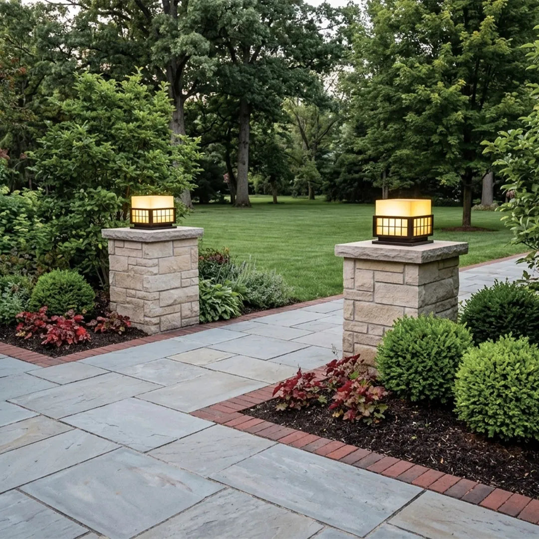Modern outdoor pillar lights mounted on entry columns creating warm architectural lighting.