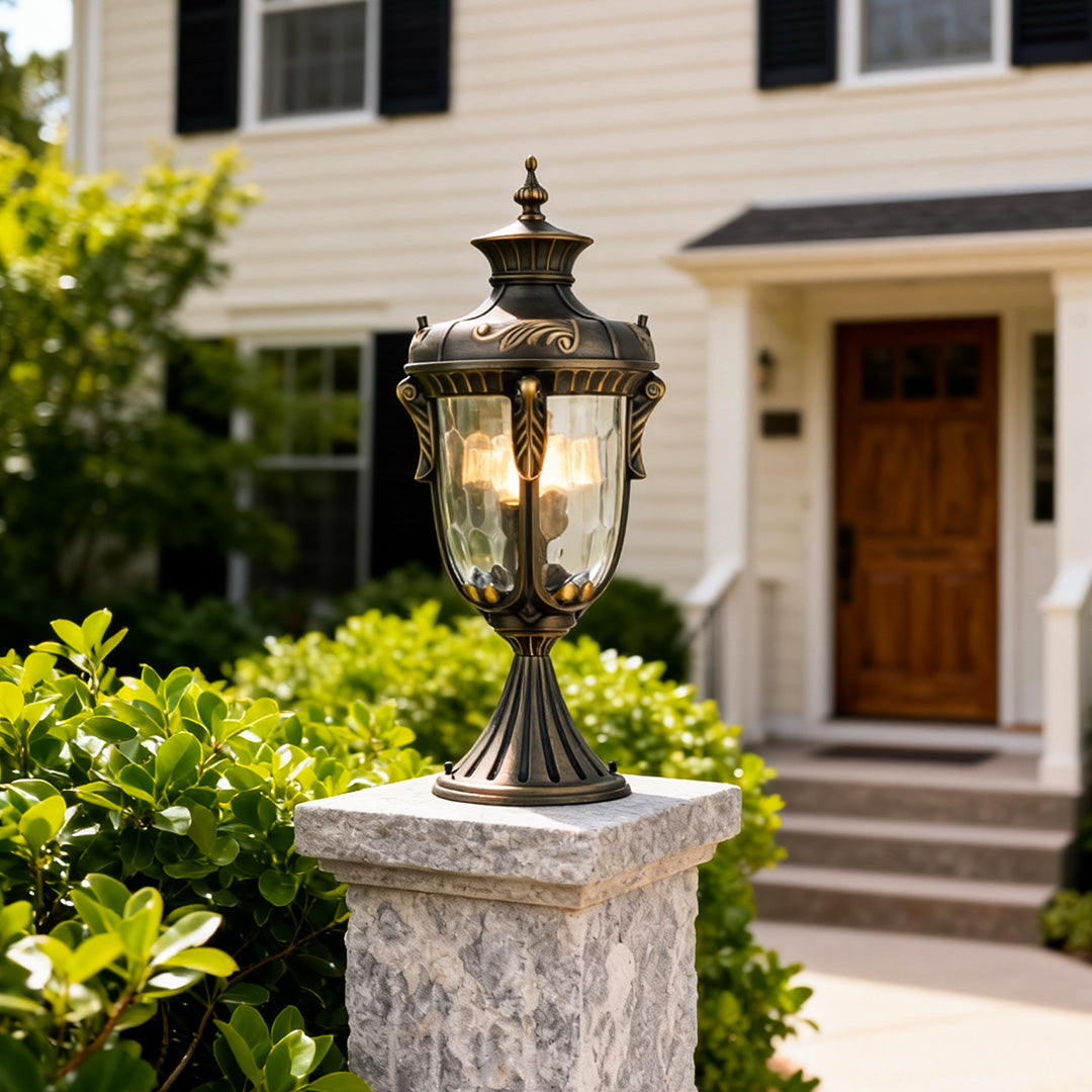 Modern outdoor pillar lights for house illuminating a garden pathway beside a beautiful home.