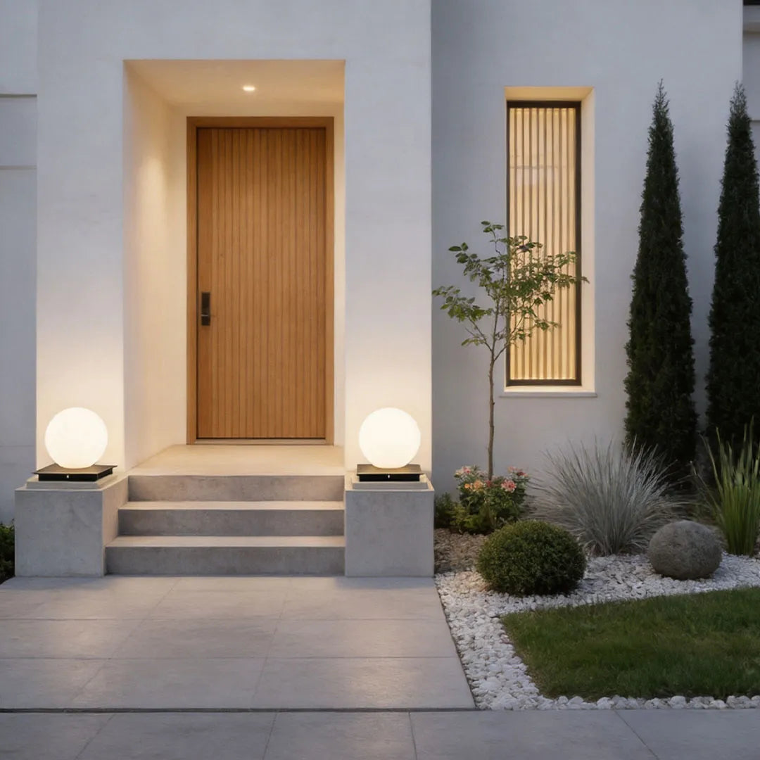 Modern outdoor pillar lights positioned at a front entry walkway, framing the steps with a clean contemporary look.