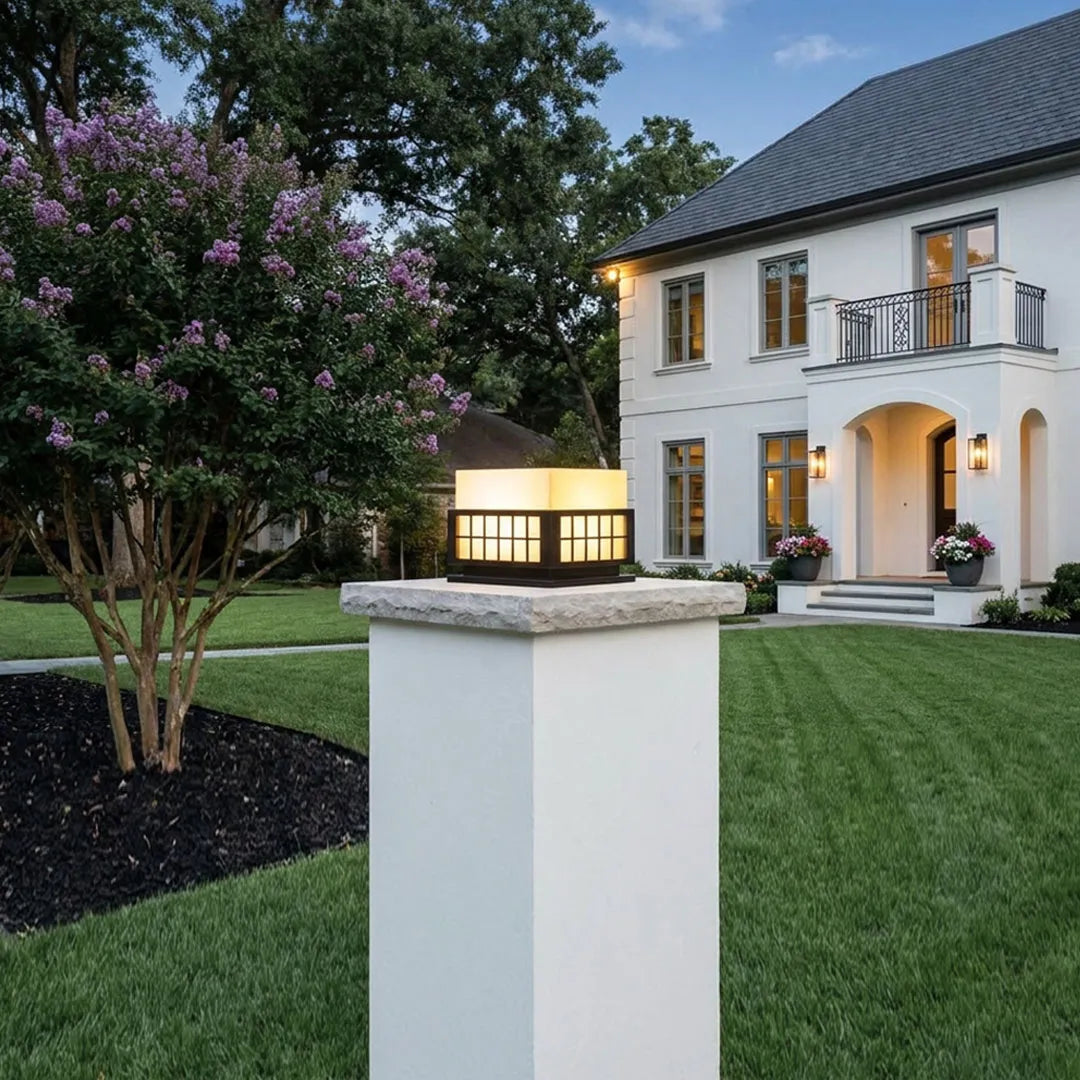 Modern outdoor pillar lights mounted on entrance pillars in a contemporary residential landscape.