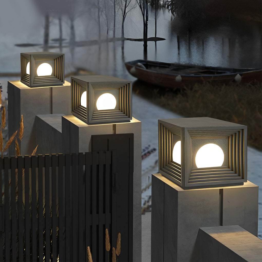 Modern outdoor pillar lights with a modern design, enhancing a backyard setting.