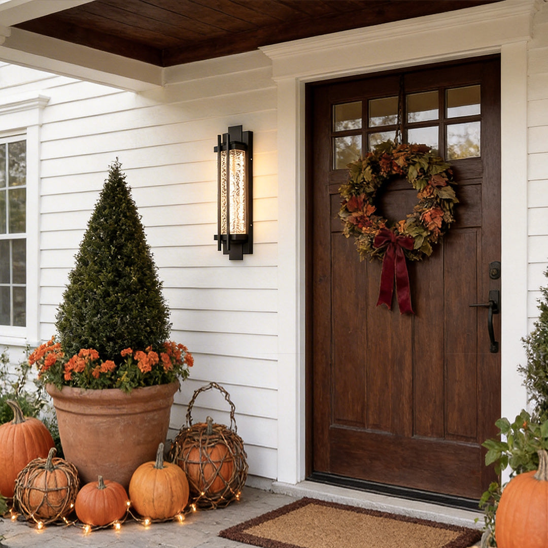 Modern outdoor sconce lighting with a contemporary design, illuminating a wooden front door.