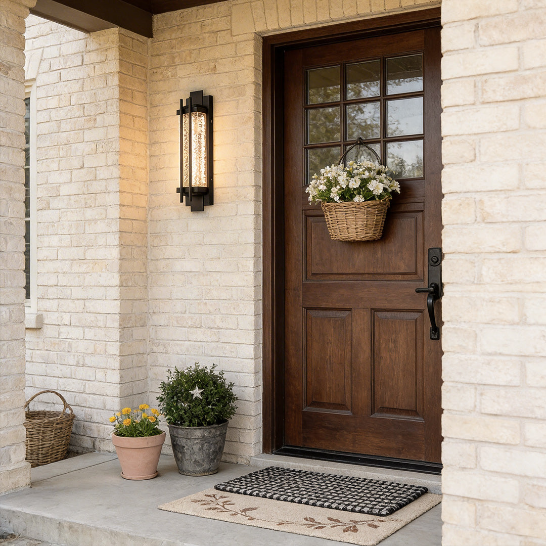Modern outdoor sconce lighting with a rectangular design, providing warm illumination near a porch.