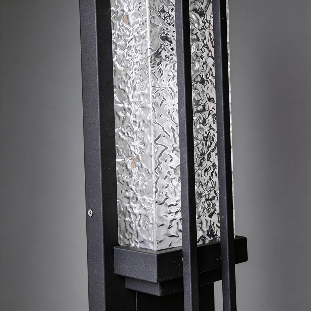 Modern outdoor sconce lighting with a sleek design, mounted on a white wall.