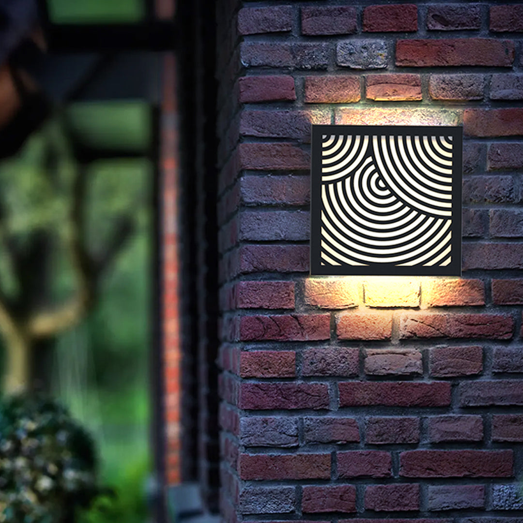 Brick wall featuring decorative modern outdoor sconces black producing warm accent and shadow patterns.