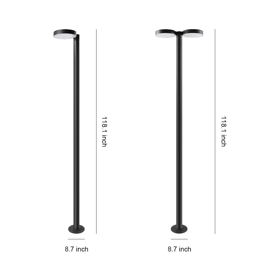 Modern outdoor street light illuminating a pathway in a quiet urban area at dusk.