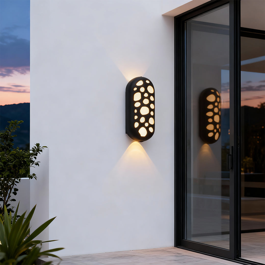 Modern outdoor up down wall lights featuring glass shade chandelier styling creating dramatic bidirectional illumination on modern patio.