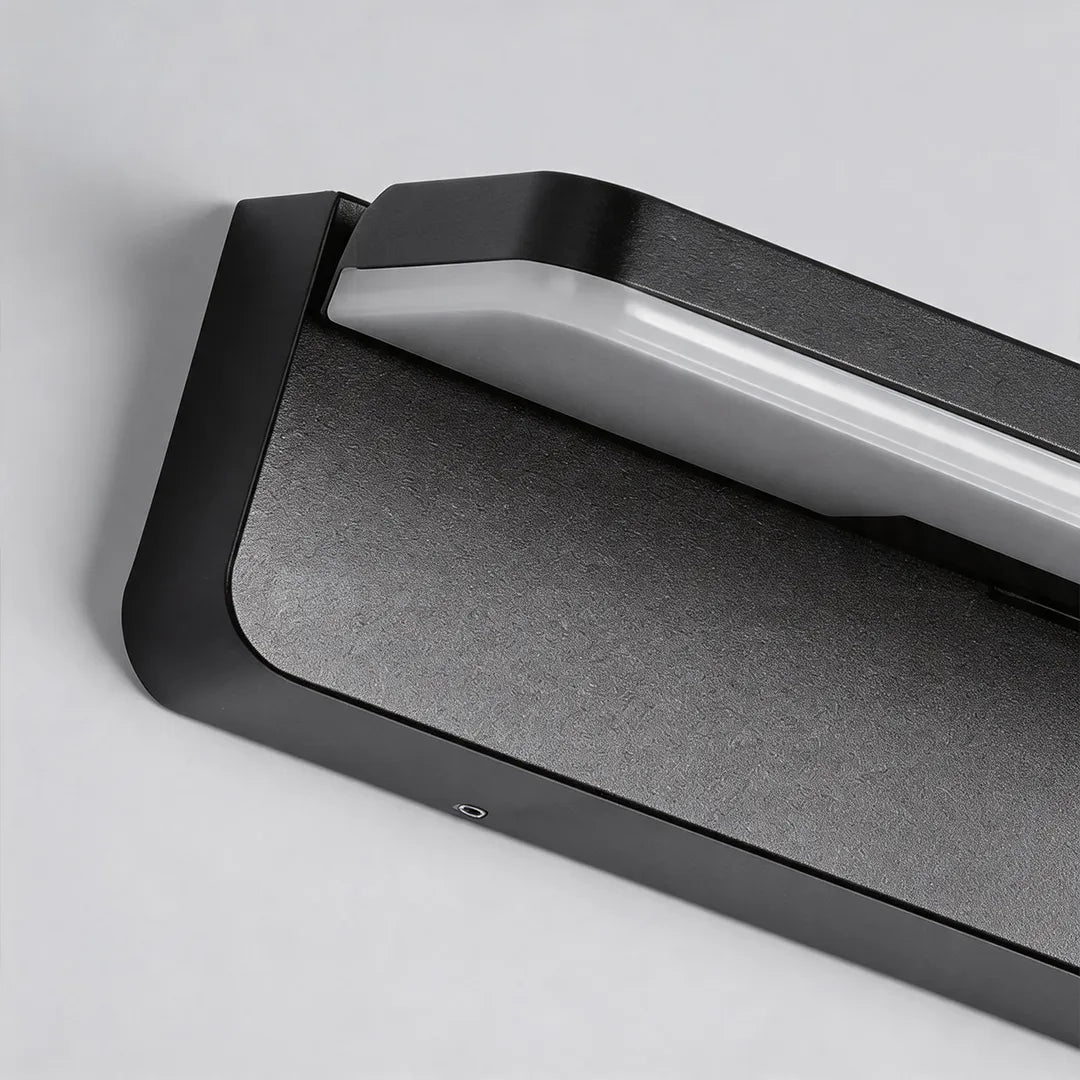 Modern outdoor wall light with textured black metal housing and LED diffuser detail