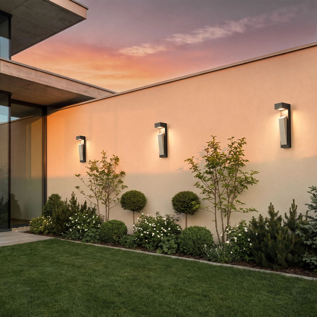 Modern outdoor wall light arranged in a row on a clean exterior wall at dusk.