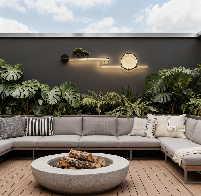 Modern outdoor wall lights with circular LED design mounted on a concrete garden wall daytime.