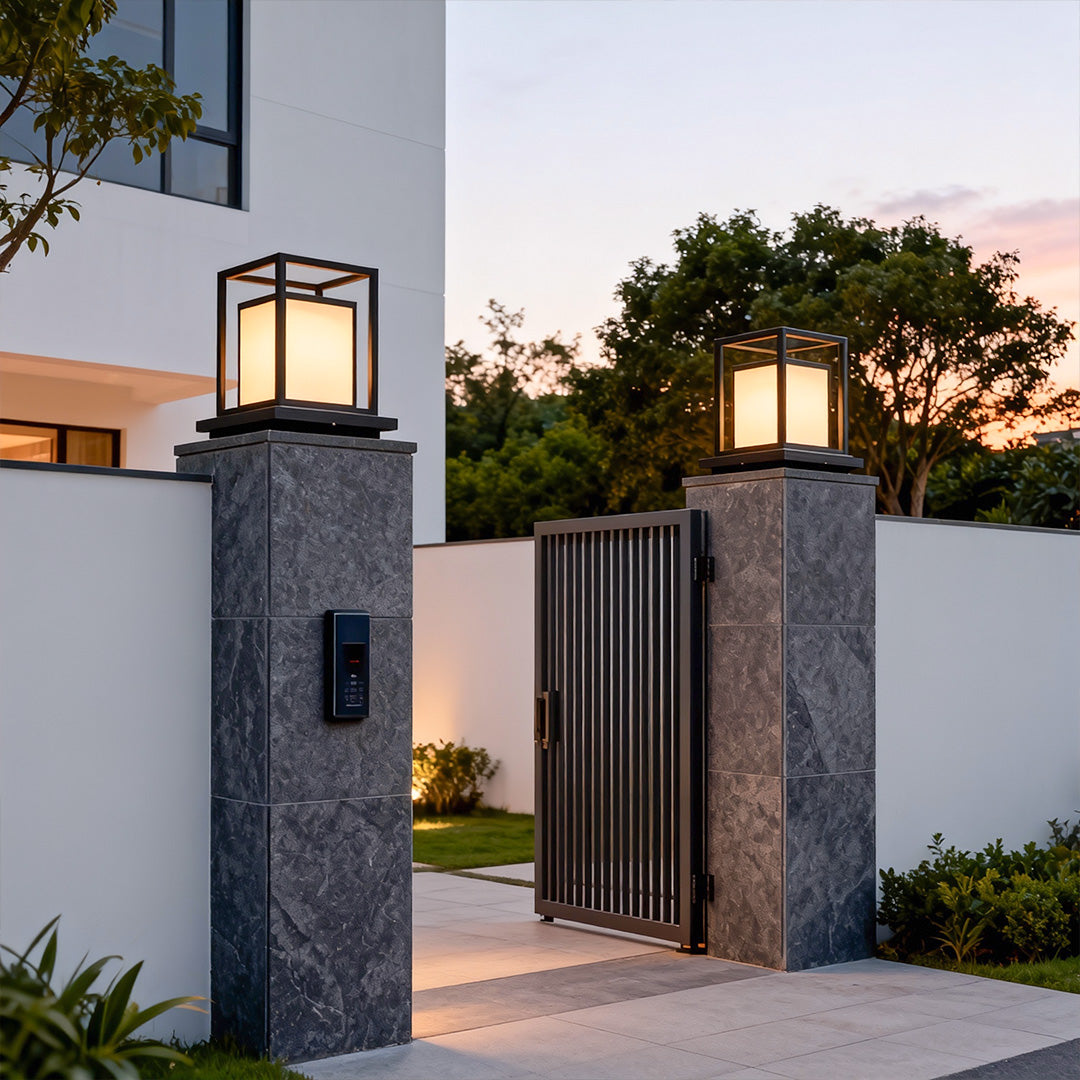 Modern outdoor wall pillar light mounted on entrance gate columns with elegant warm illumination.