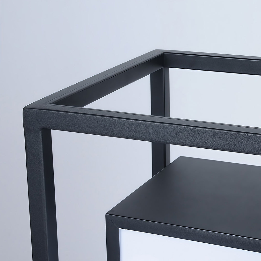 Modern outdoor wall pillar lights close up showing black metal frame and frosted panels.