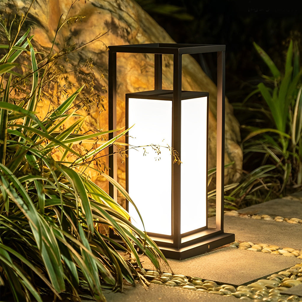 Modern outdoor wall pillar lights positioned beside plants, providing soft accent lighting.
