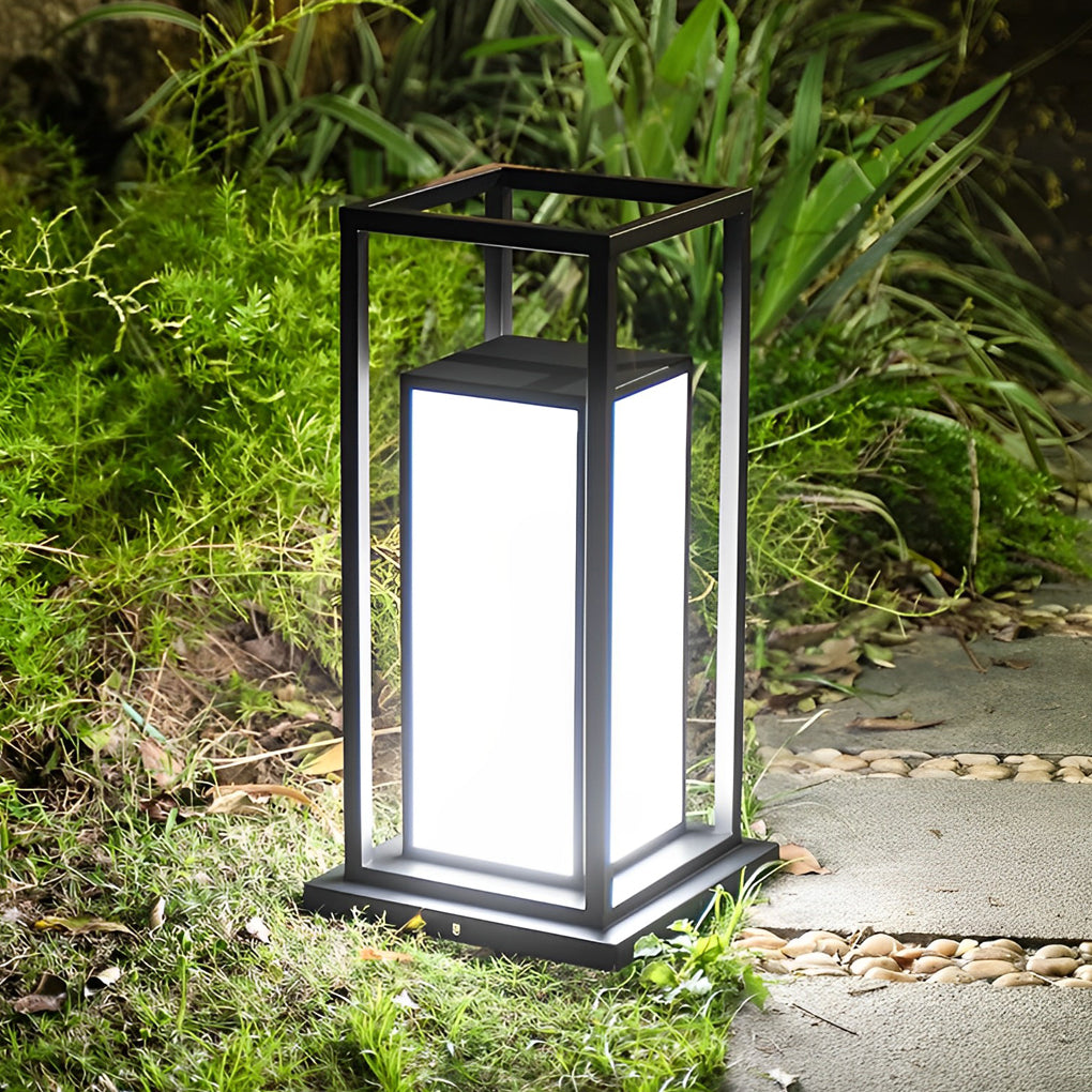 Modern outdoor wall pillar lights standing on stone base along landscaped garden path.