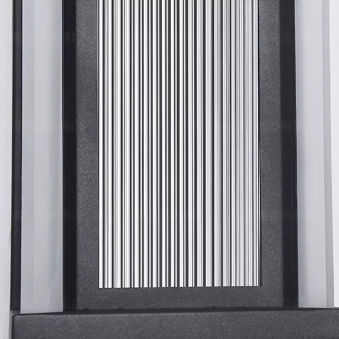 Modern outdoor wall sconce with textured black frame and ribbed glass diffuser