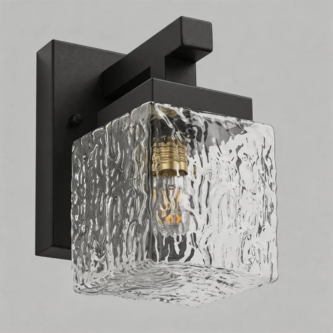 Modern outdoor wall sconce with square textured glass shade and visible bulb