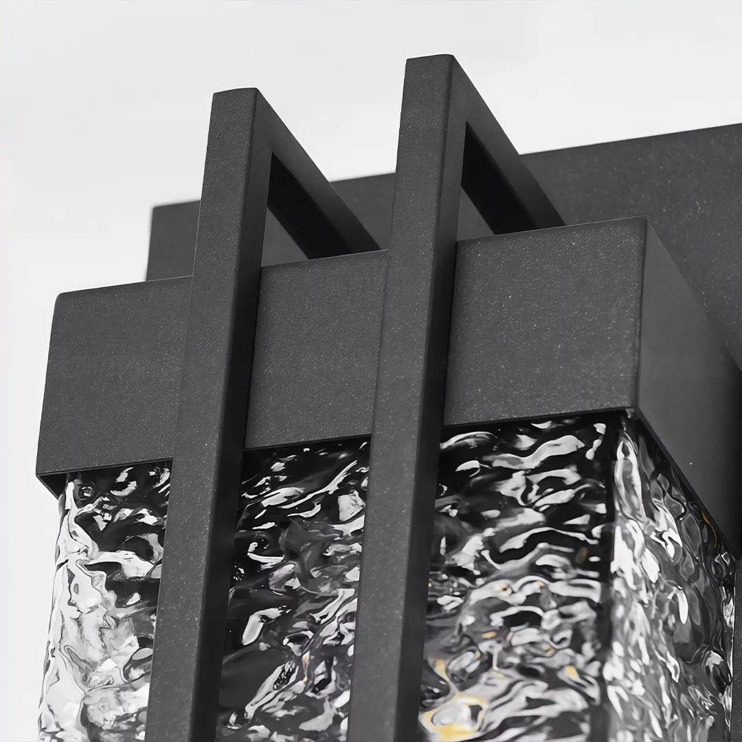 Modern outdoor wall sconce with black metal mounting bracket detail