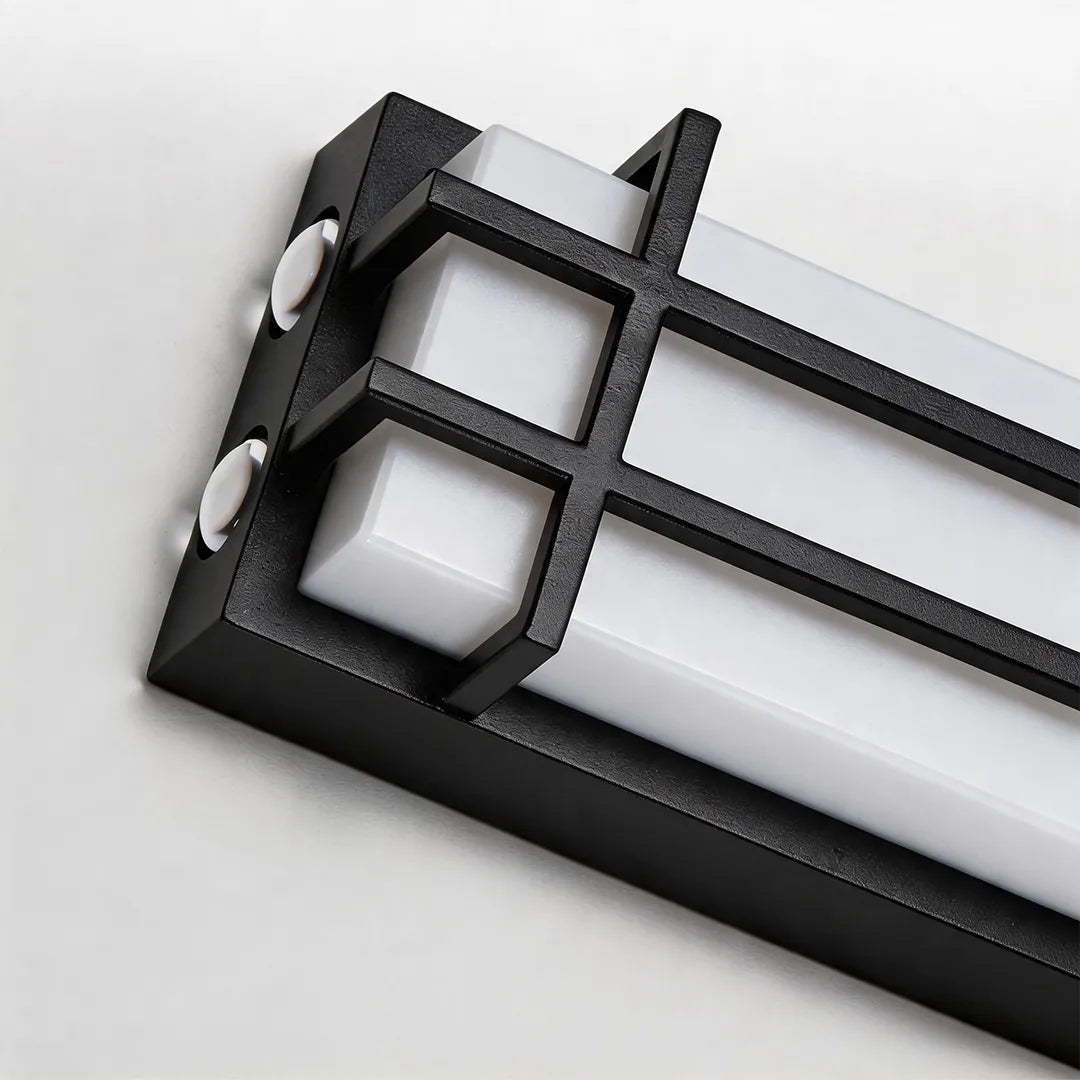 Modern outdoor wall sconce with black metal mounting frame and diffuser detail