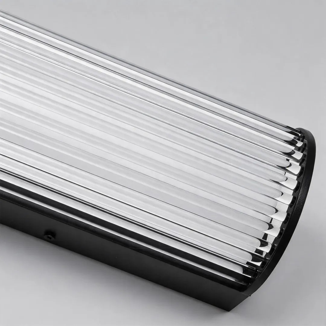 Modern outdoor wall sconce with vertical ribbed glass and black metal housing