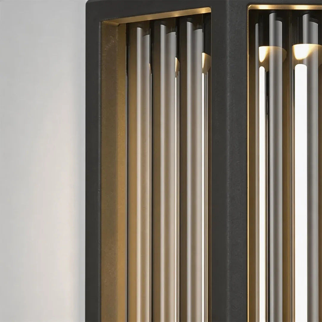 Modern outdoor wall sconce with vertical black metal bars and warm LED lighting