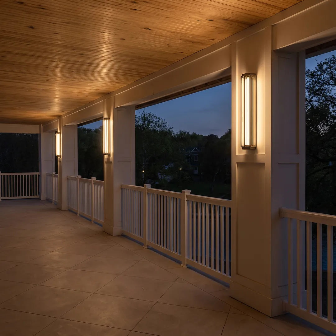 Modern outdoor wall sconces illuminating covered porch and outdoor walkway