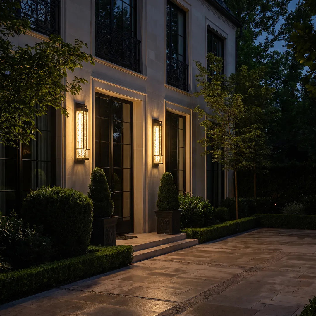 Modern outdoor wall sconces illuminating elegant home entrance at night