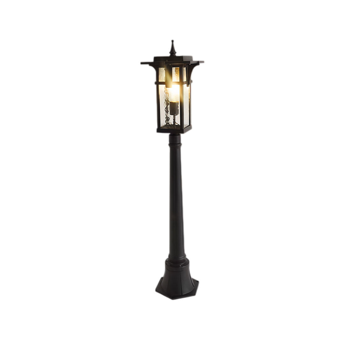 Modern path light with black metal frame and clear glass panels, displayed from a three-quarter angle.