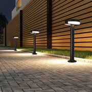 Modern pathway lighting lining contemporary paved walkway beside wood fence creating architectural nighttime illumination