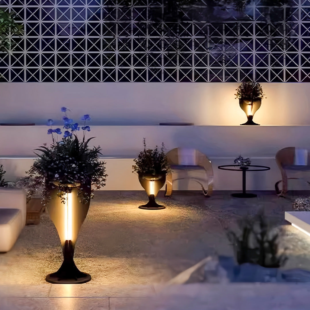 Modern patio scene featuring multiple lighted planter pots providing ambient outdoor lighting at night.