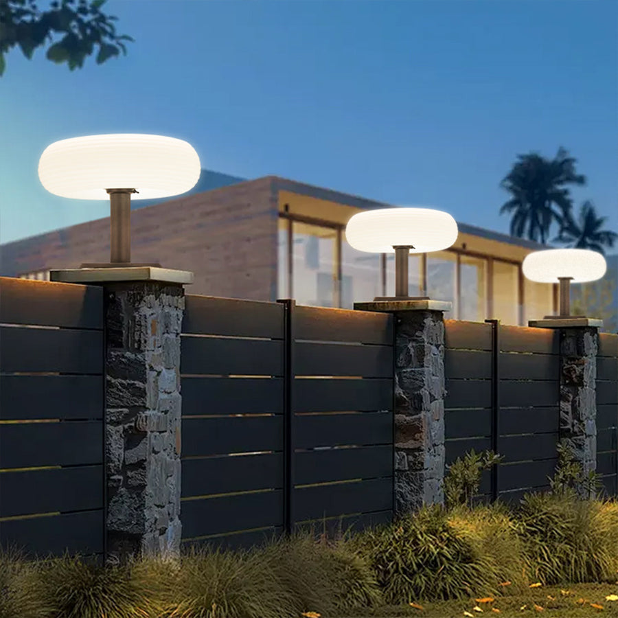 Contemporary pillar lights installed along modern residential fence creating architectural accent lighting