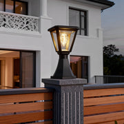 Contemporary concrete post topped with elegant led post cap lights, enhancing the entrance of a modern house.