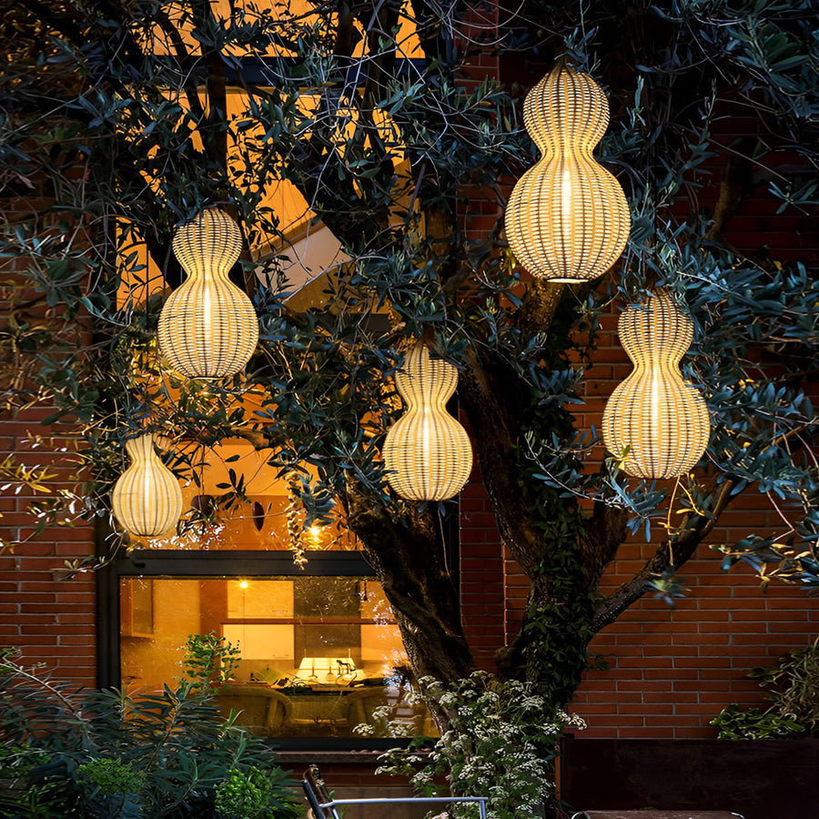 Modern rattan pendant light illuminating a courtyard patio, combining natural woven design with soft ambient lighting.