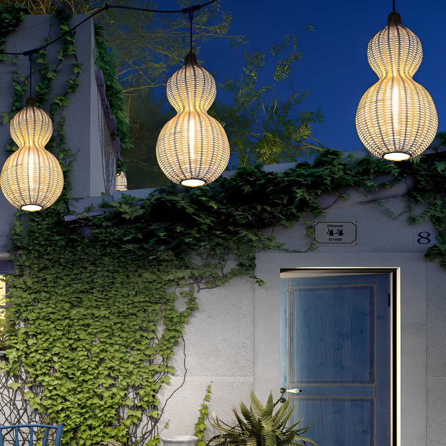Modern rattan pendant light illuminating an exterior wall and doorway, enhancing outdoor charm with woven light design.