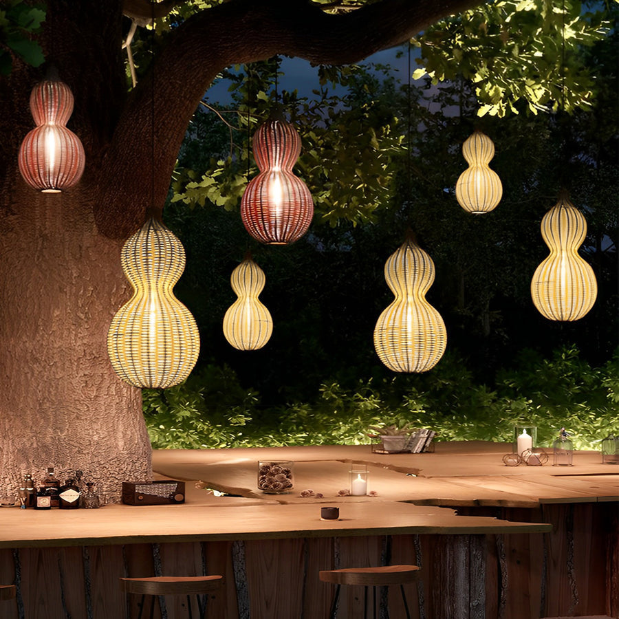 Modern rattan pendant light group arranged in a garden seating space, adding decorative lighting for evening gatherings.