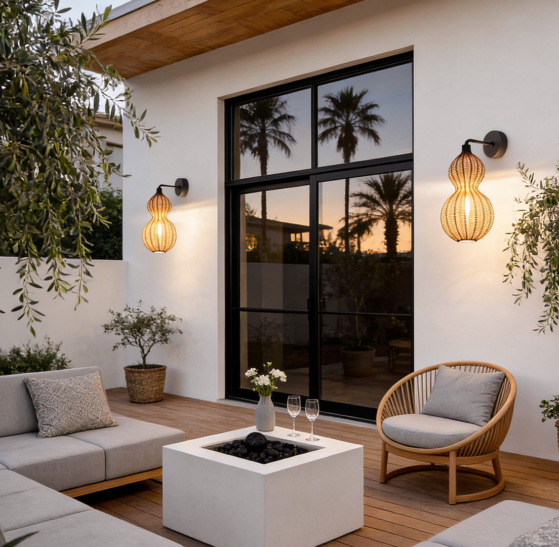 Modern rattan pendant light mounted near a contemporary outdoor lounge, adding soft woven texture and warm evening glow.