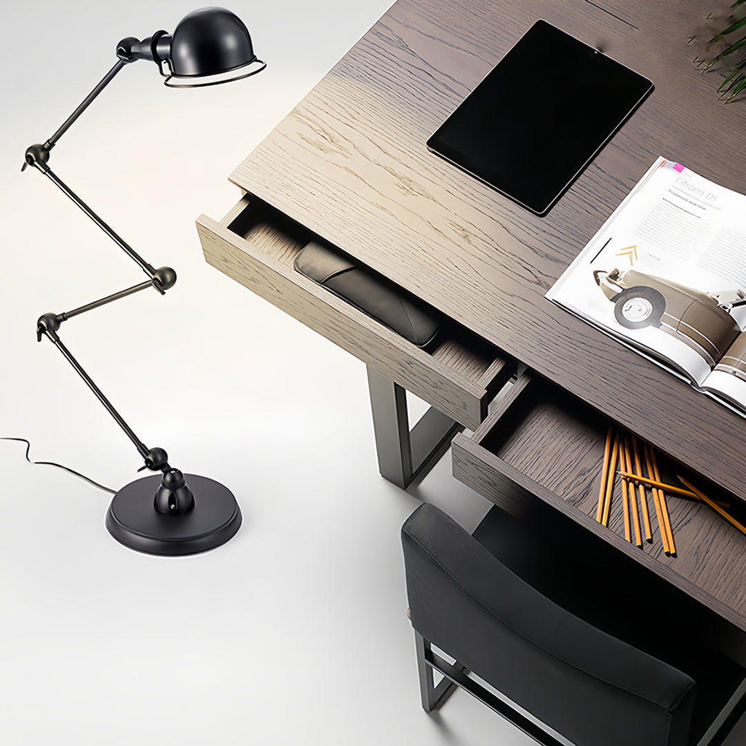 Modern reading floor lamp with black adjustable design positioned beside contemporary desk workspace