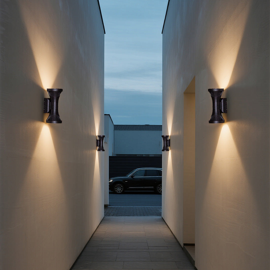 Modern residential walkway illuminated by symmetrically placed Outdoor Wall Lighting Fixtures on opposing walls.