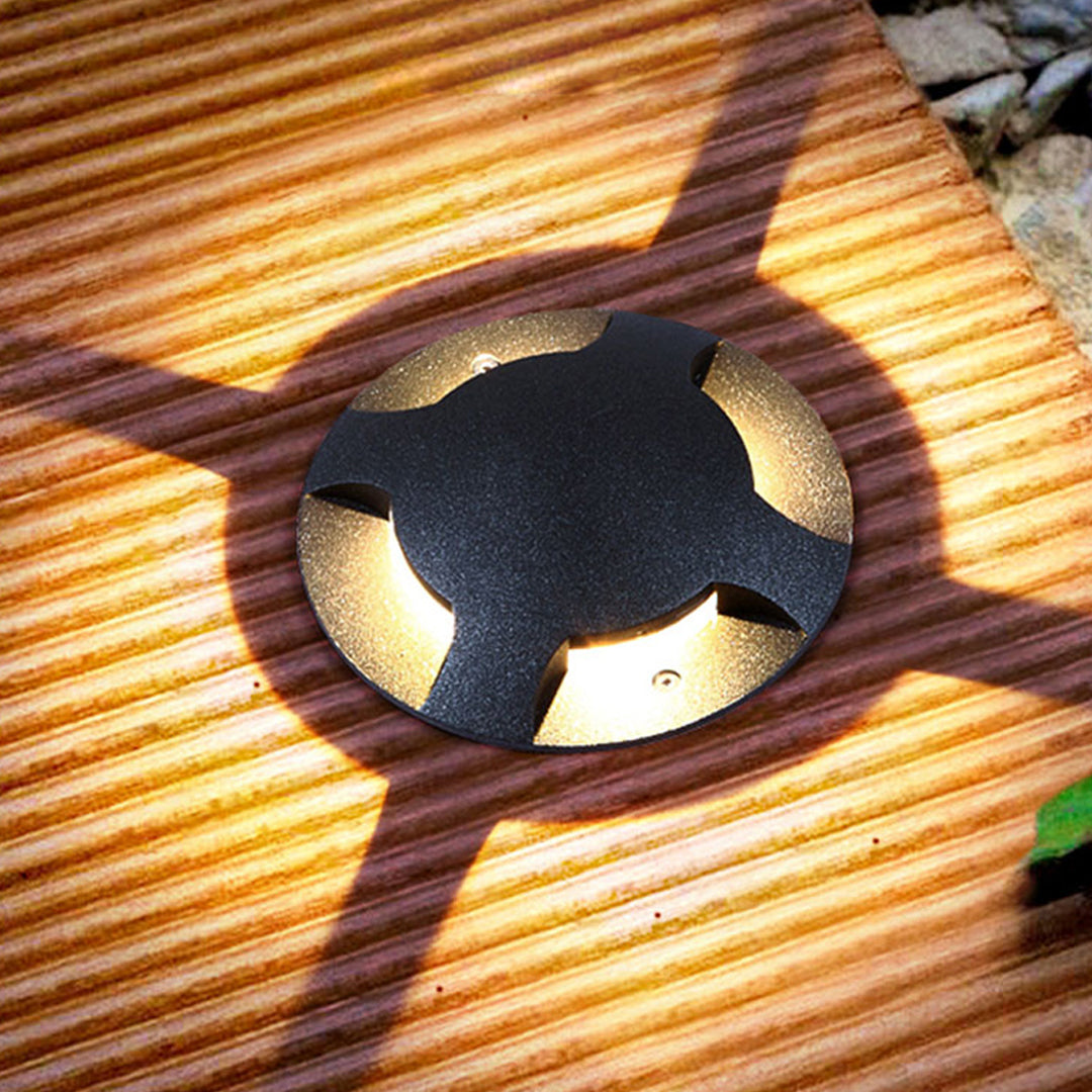 Close-up view of black cylindrical ground fixture showing precision-engineered directional design