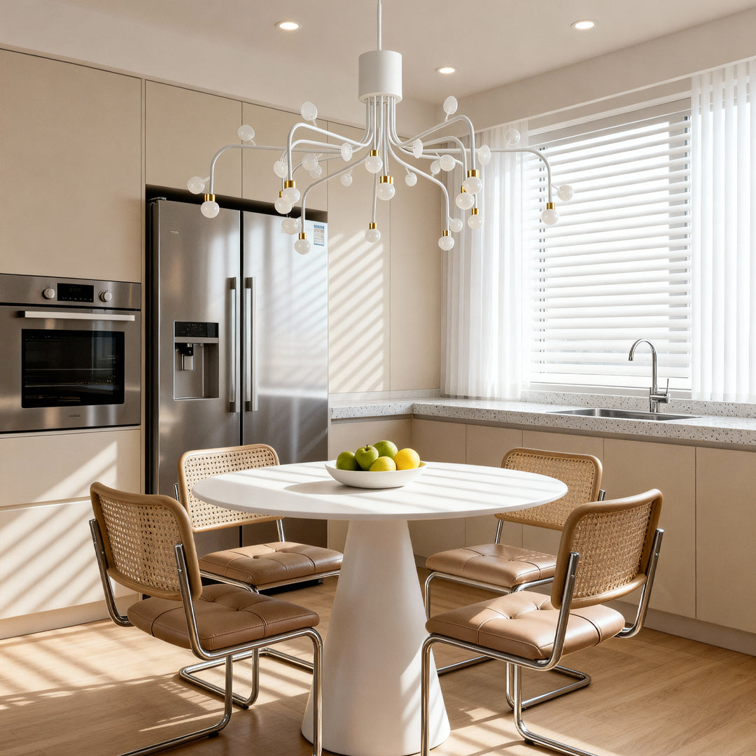 Modern retro chandelier providing focal lighting above white round table in bright kitchen with modern cabinetry