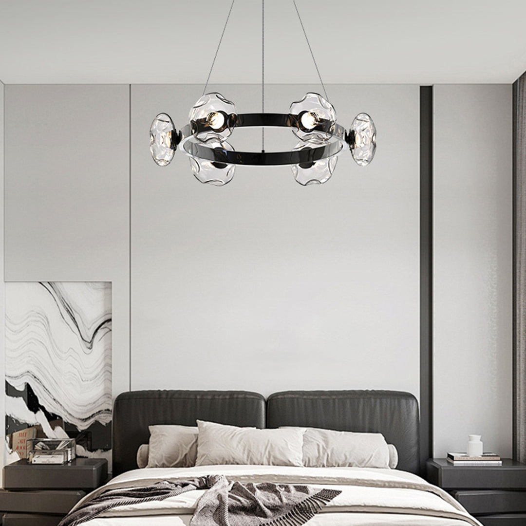 Modern ring chandelier installed above contemporary bedroom with sleek circular design and glass elements