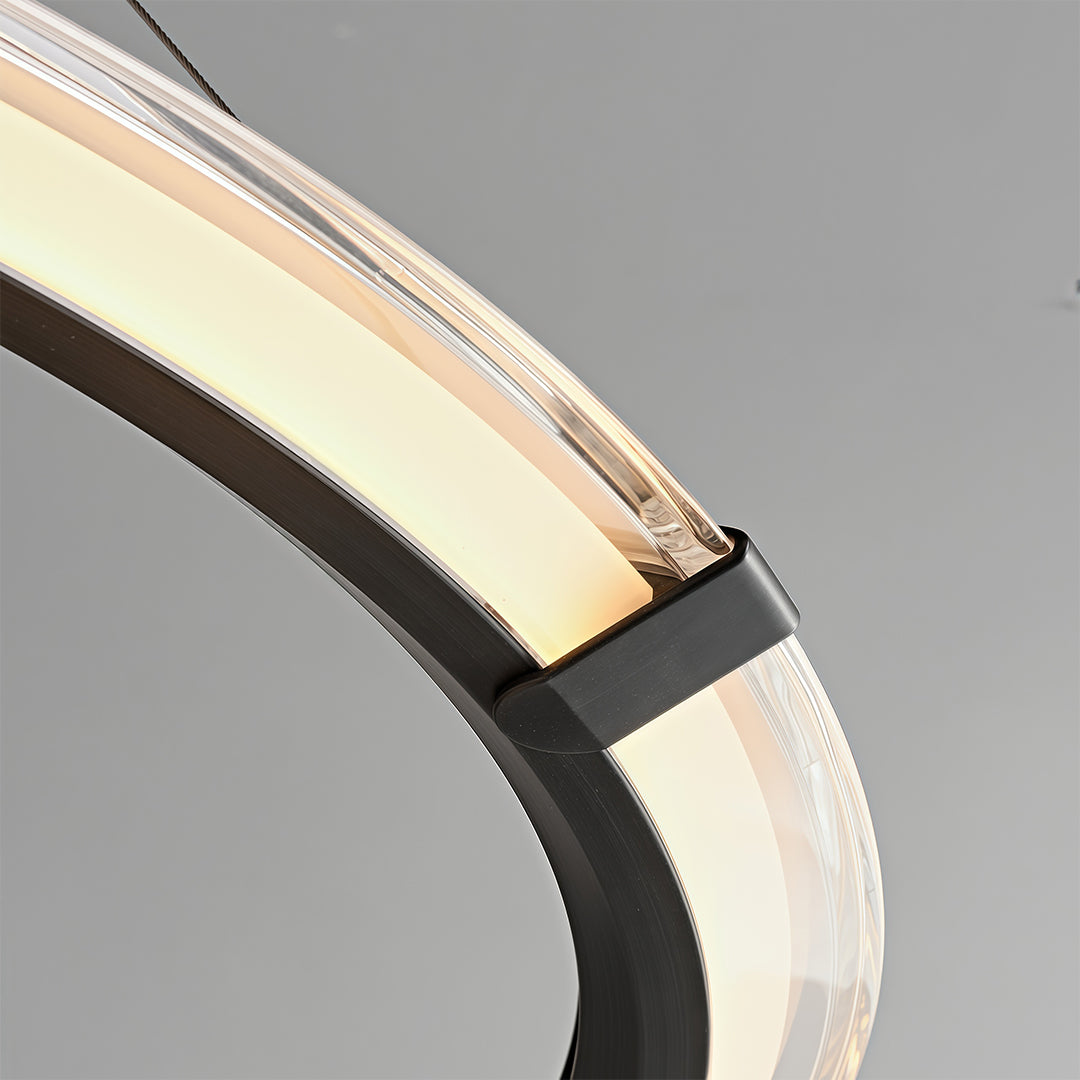 Modern round chandelier with a black finish suspended in a modern dining room