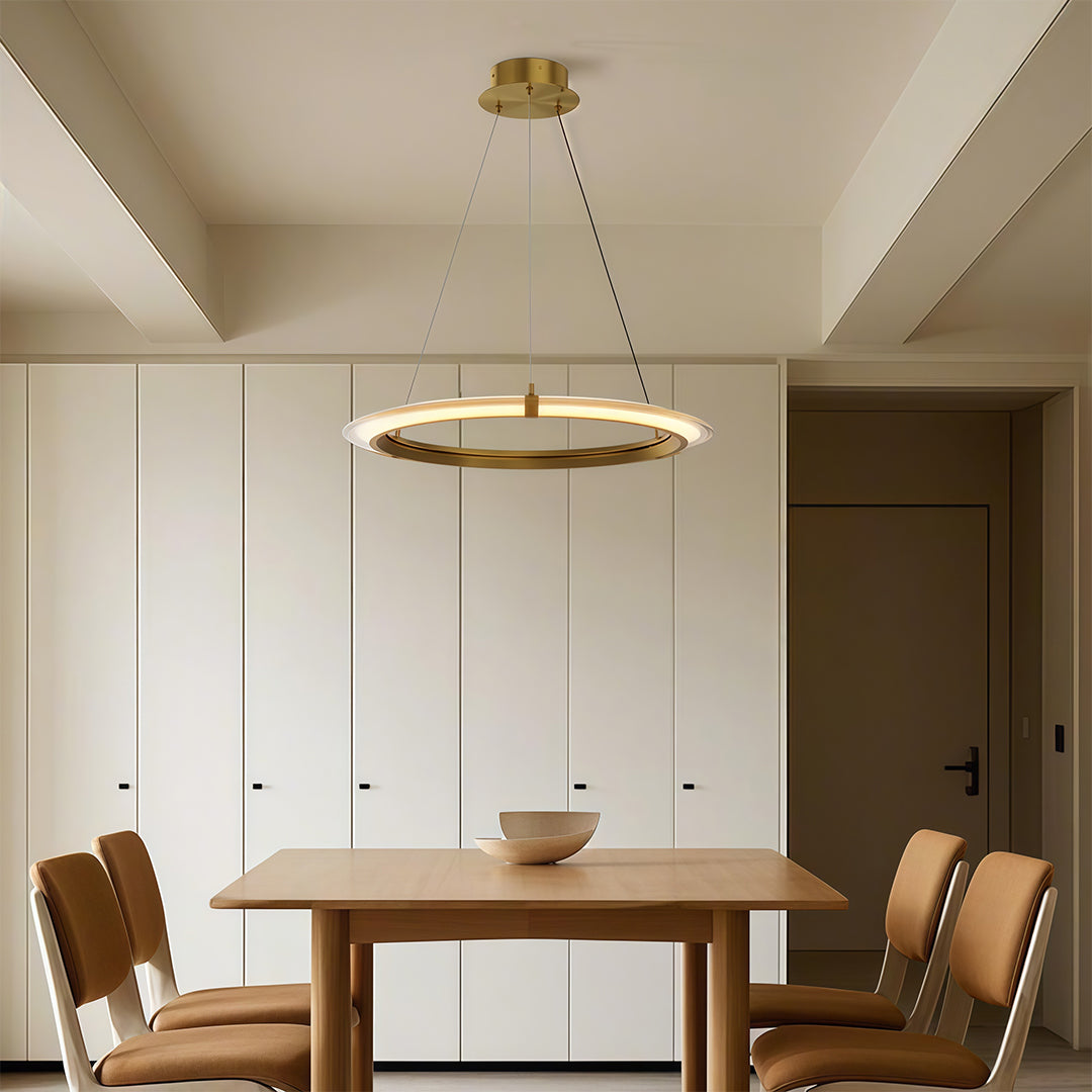 Dining room featuring a modern round chandelier with a clean circular ring above a dining table.
