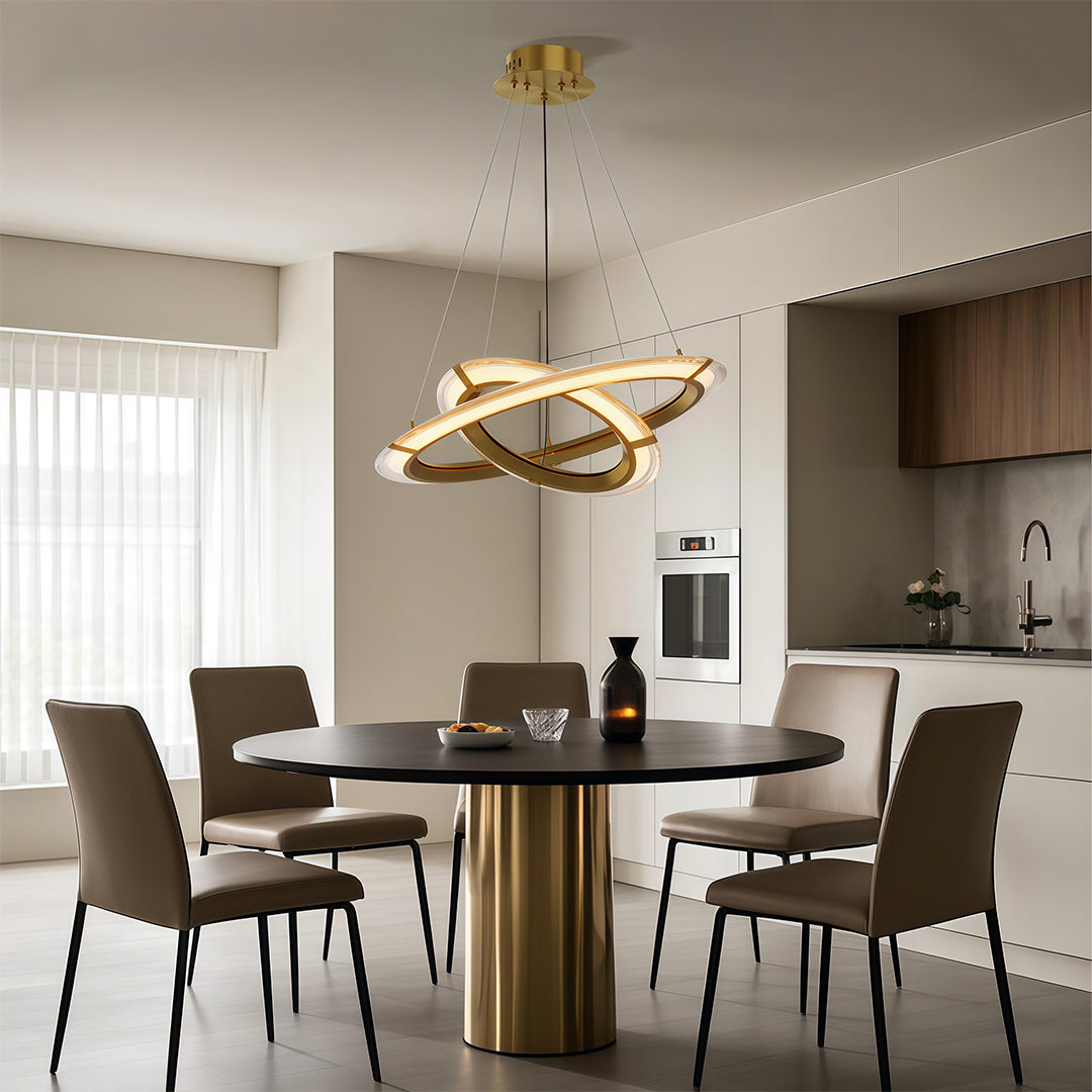 Minimalist dining area illuminated by a multi-loop modern round chandelier.