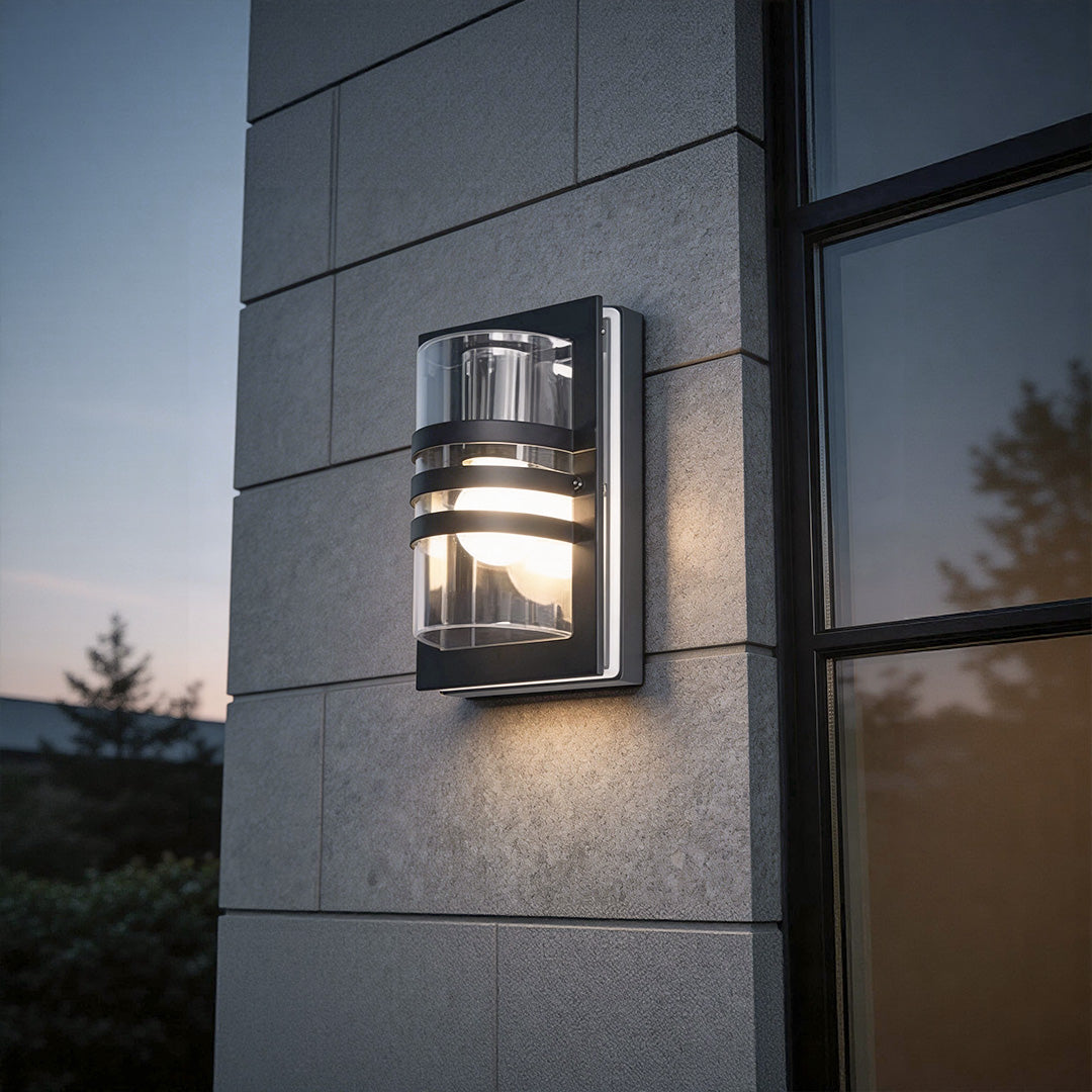 Modern sconces outdoor with a cylindrical design, providing warm illumination near a porch.