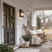Modern sconces outdoor with a sleek design, enhancing a cozy porch seating area.